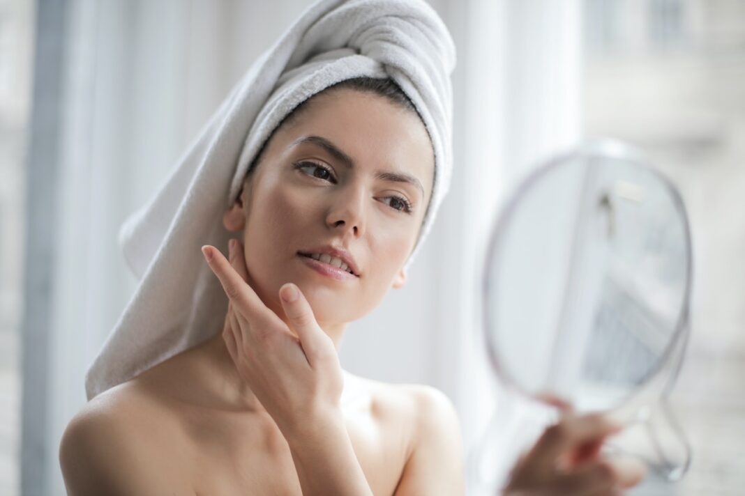 Sursa: https://www.pexels.com/photo/selective-focus-portrait-photo-of-woman-with-a-towel-on-head-looking-in-the-mirror-3764013/